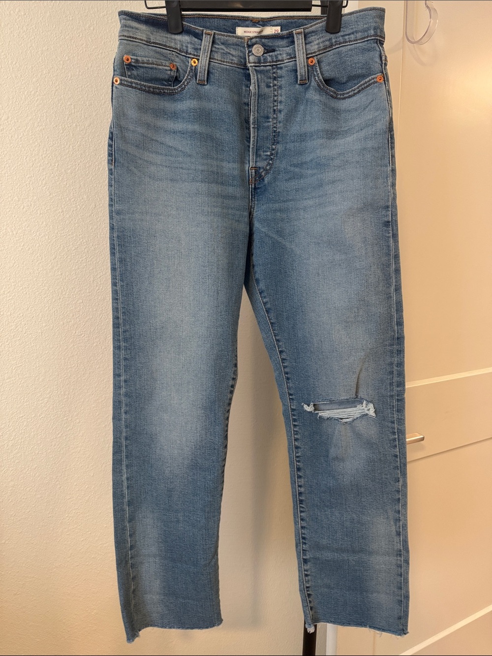 Levi Wedgie Straight Women's Jeans - Light Blue size 29 distressed raw hem edge.